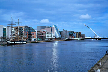 View of the River Liffey in Dublin with modern buildings near the restored docklands area - 598621245