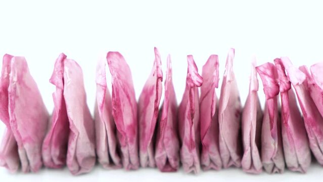 Used tea bags are dried in a row by the window sill. Compostable, Reusable or Trash