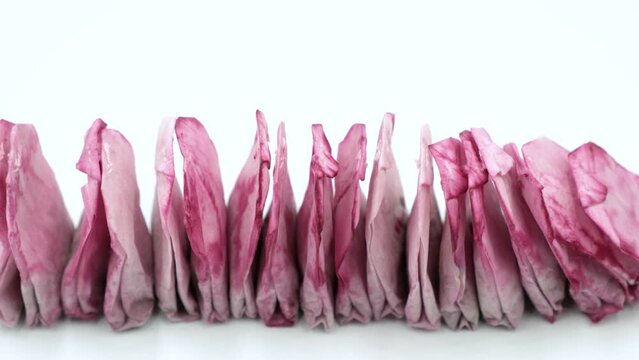 Used tea bags are dried in a row by the window sill. Compostable, Reusable or Trash