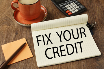 Fix Your Credit open notepad near calculator and cup of coffee