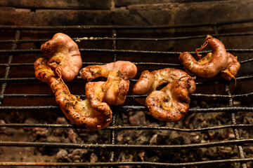Cow bowels presented on a wooden board with ingredients, ready to grill