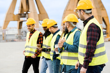 Group of engineer people working at cargo terminal at maritime port - Main focus on African woman face