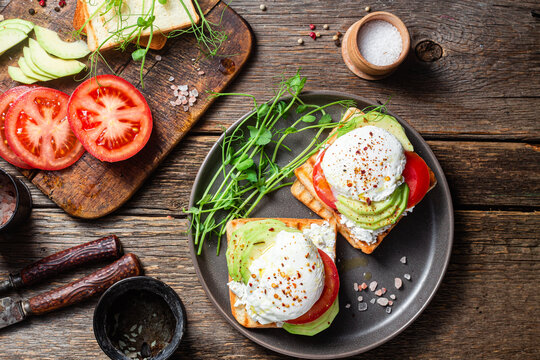 Toast with poached egg, tomatoes and avocado. Healthy breakfast