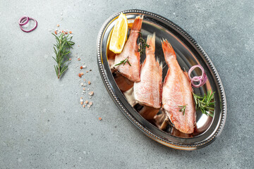 red fish with lemon, rosemary, salt. banner, menu, recipe place for text, top view