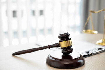 Close up gavel of lawyer and justice scale.