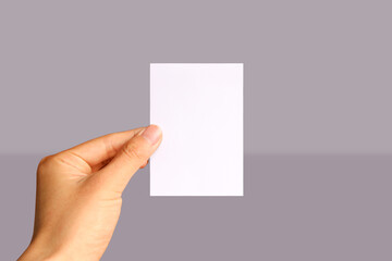 Realistic hand holding A7 paper mockup. Portrait A7 international paper size mockup. Simple, clean, modern, minimal paper mock up. Paper mockup in hand