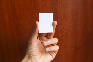 Hand holding A9 paper mockup. Portrait A9 international paper size mockup. Simple, clean, modern,...