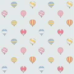 Seamless pattern of cute hot air balloons in multicolors and patterns against a blue sky. Great for nurseries, children's clothes, stationery, bedspreads and more.