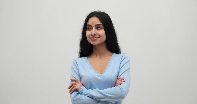 Portrait of smiling young woman in blue top with her arms crossed over white background Generative AI