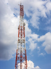 View of a large red-and-white telecommunication tower.