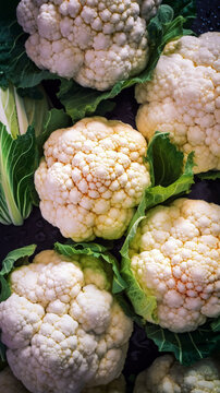 Fresh tasty Cauliflowers in water drops on dark background. Pro studio shot. Digitally generated AI image