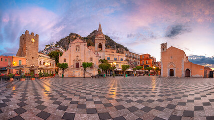 Taormina, Sicily, Italy. Panoramic cityscape image of picturesque town of Taormina, Sicily with main square Piazza IX Aprile and San Giuseppe church at sunrise. - 598640212