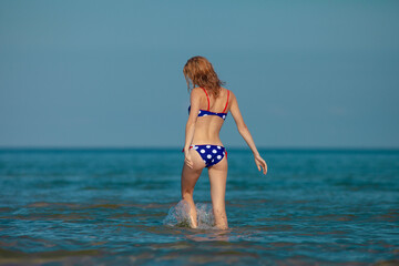 Fototapeta na wymiar Beautiful woman in bikini on the beach