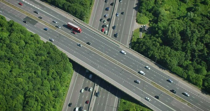 
Aerial View of Traffic over a Major Highway Interchange, Full of Cars and Trucks.  London. England. Shot in 8K from Helicopter.
