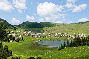 Scenic viewpoint over Prokosko lake in Bosnia and Herzegovina. Sunny day with clouds. Rural life...