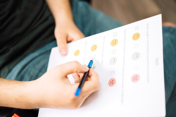 Man taking a psychological test with emoticons.