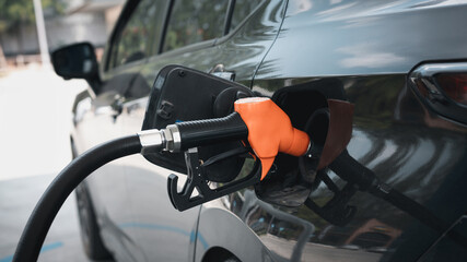 Gasoline being refilled at a petrol station. Refueling Diesel fuel is used to power a car.