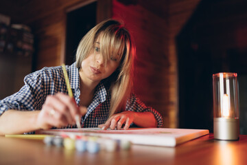 Fototapeta premium Painting by numbers concept. Young girl enjoying coloring picture by numbers. Creative hobby.