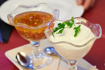 Vinaigrette sauces in the background and mayonnaise in the foreg