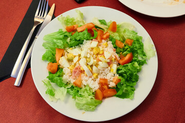 Salad with boiled egg, tomato rice and ham