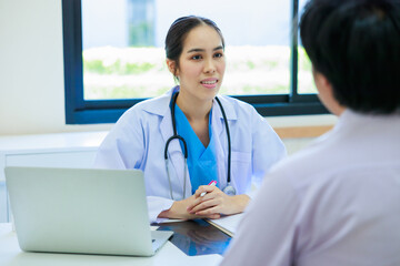 Portrait Asian woman doctor and asian man patient. Smiling female doctor talking consulting with patient. Hospital Healthcare and medicine concept.