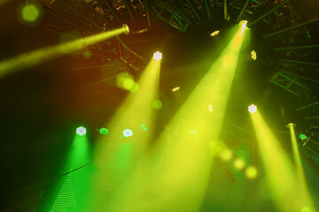 Stage light with colored spotlights and smoke, colorful abstract blurred bokeh