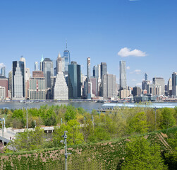 panorama of Manhattan and brooklyn bridge across the East River from Brooklyn