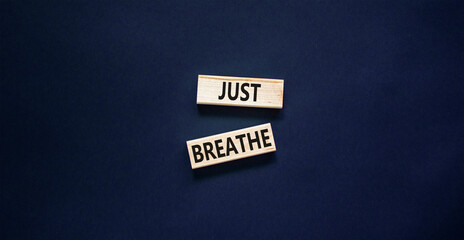 Just breathe and psychological symbol. Concept words Just breathe on beautiful wooden block. Beautiful black table black background. Business psychological and Just breathe concept. Copy space