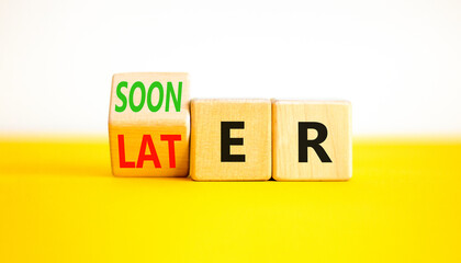 Sooner or later symbol. Businessman turns wooden cubes and changes the word Later to Sooner. Beautiful yellow table white background. Copy space. Business and sooner or later concept.