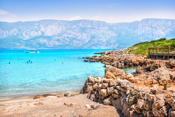 Emerald water and rocky beach at Cleopatra Island, Sedir Island, Aegean Sea, Marmaris, Turkey