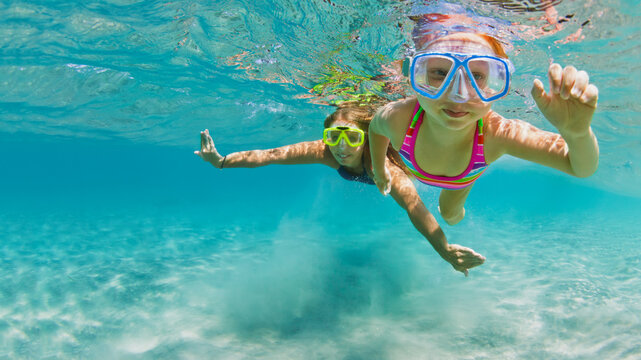 Young Mother With Child In Snorkeling Mask Dive In Coral Reef Sea Lagoon To Explore Underwater World. Family Travel Lifestyle In Summer Adventure Camp. Swimming Activities On Beach Vacation With Kids.