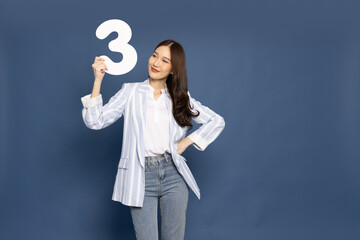 Young Asian woman showing number 3 or three isolated on blue background