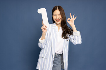 Young Asian woman showing number 1 and OK sign isolated on blue background