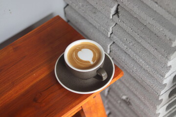 latte art on te wood table in the coffee shop