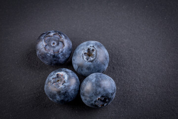Blueberries on stone plate background
