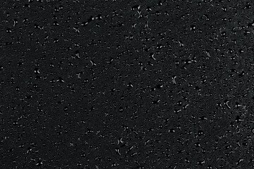 Water drops on dark stone
