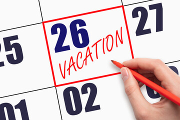 26th day of the month. Hand writing text VACATION on calendar date.