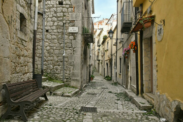 Fototapeta na wymiar A narrow street among the old houses of Guardia Sanframondi, a small town of Benevento province, Italy.