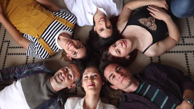 group of friends selfie, lying on their backs