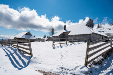 Picturesque view of traditional mountain pasture wood cabin.