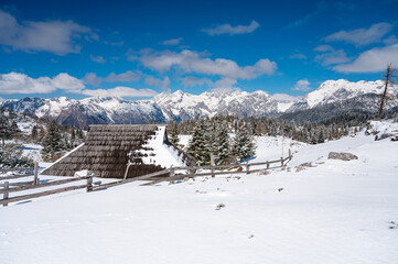 Picturesque view of traditional mountain pasture wood cabin.