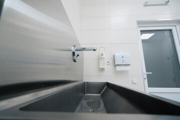 Disinfection procedure in the clinic sink in which doctors wash their hands before surgery