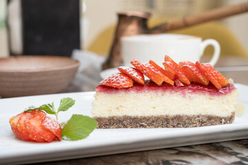 Piece of delicious cheesecake with berries on table close up