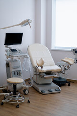 Medical office with ultrasound diagnostic equipment in the gynecological office of the clinic gynecological chair