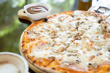 italian chicken pizza with mozarella cheese on glass table in street cafe