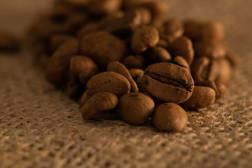 Coffee beans on a beige tablecloth. Macrophotography