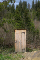 wooden toilet in the middle of the spring forest forest.