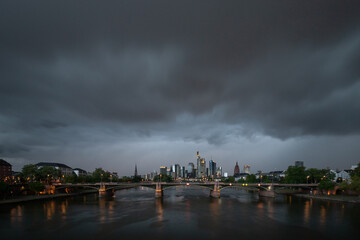 View of the financial district with the Main River and a bridge. Skyline in Frankfurt City, with thunderstorm Germany