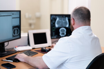 the patient undergoes computed tomography in the clinic the radiologist monitors the procedure and...