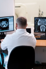 the patient undergoes computed tomography in the clinic the radiologist monitors the procedure and...